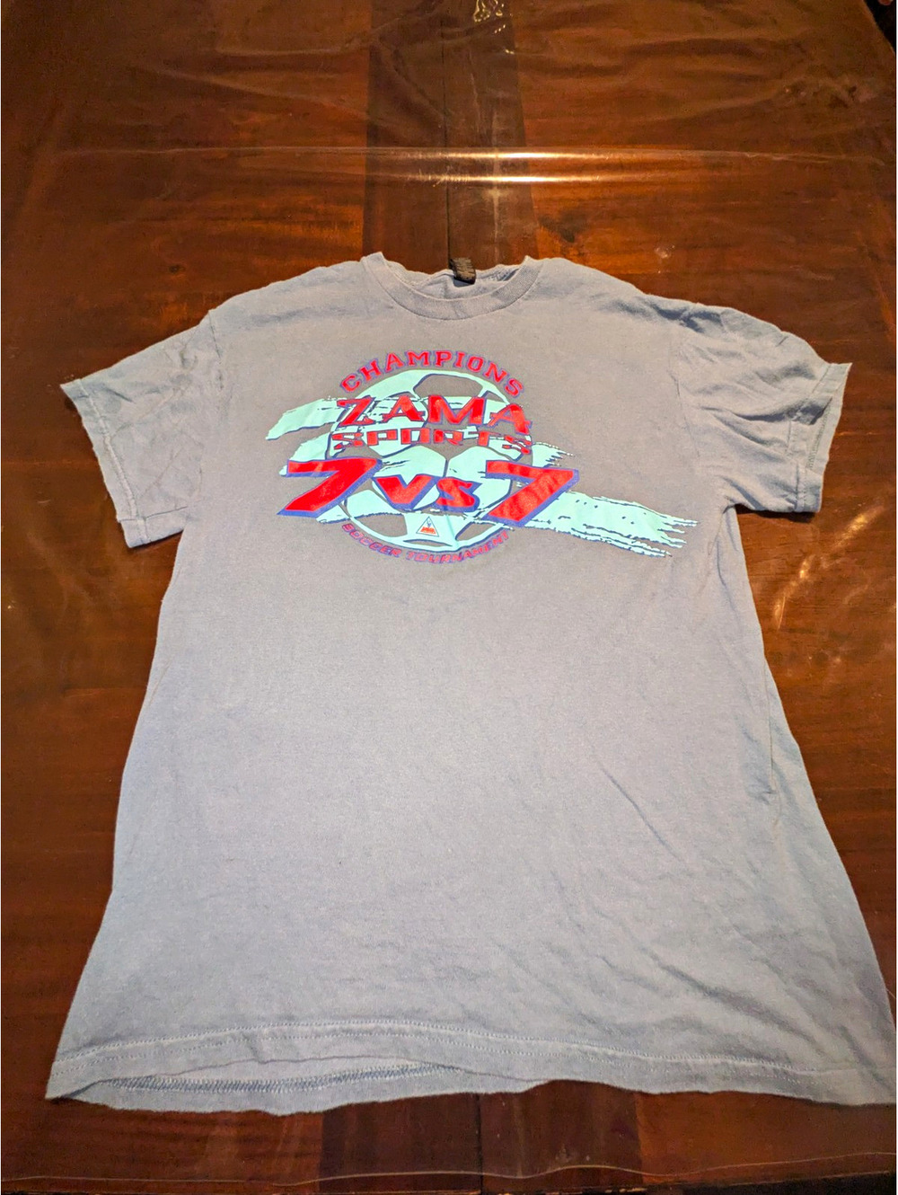 90's Zama Sports Champions 7 vs 7 Soccer Tournament on a GILDAN TSHIRT.